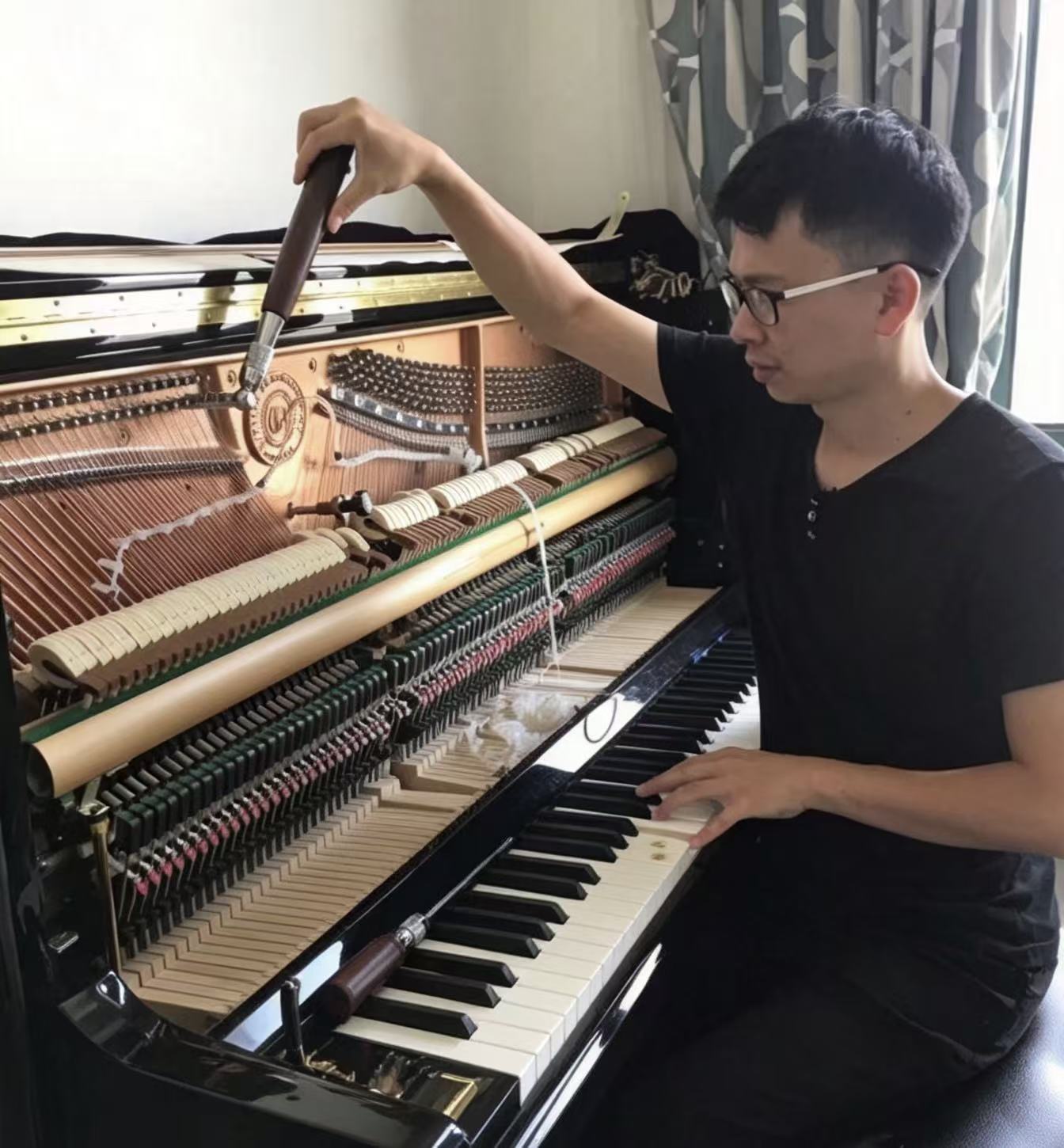 Even Wang tuning a piano